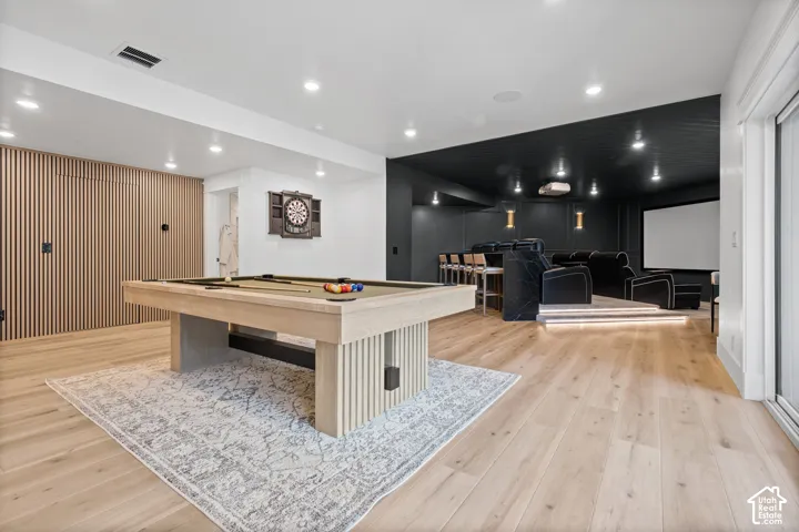Open entertainment space featuring light wood-finish flooring