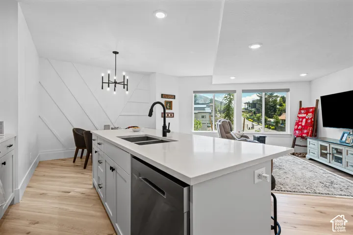 Modern kitchen island with a quartz countertop, integrated dual sink, and matte black faucet