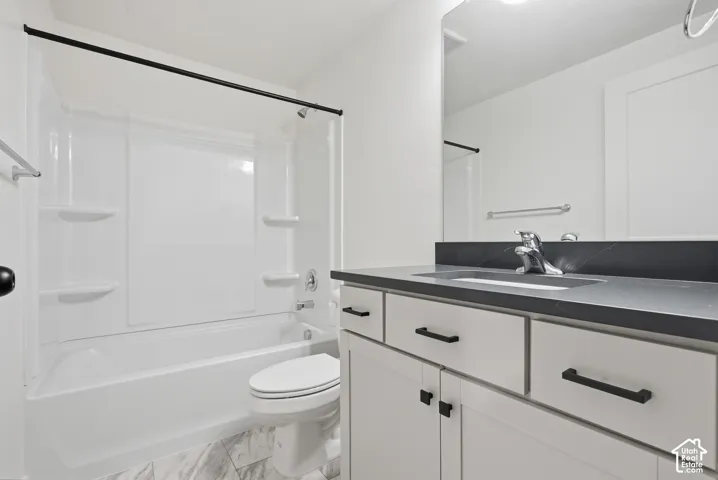 Bathroom featuring a white tub/shower combination with integrated shelving