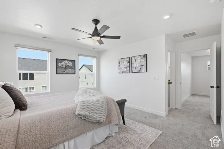 Interior space featuring a contemporary ceiling fan with integrated lighting, recessed lighting, and two windows allowing natural light
