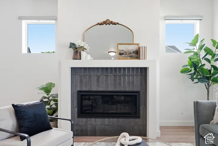 Modern fireplace featuring dark vertical tile surround and white mantel