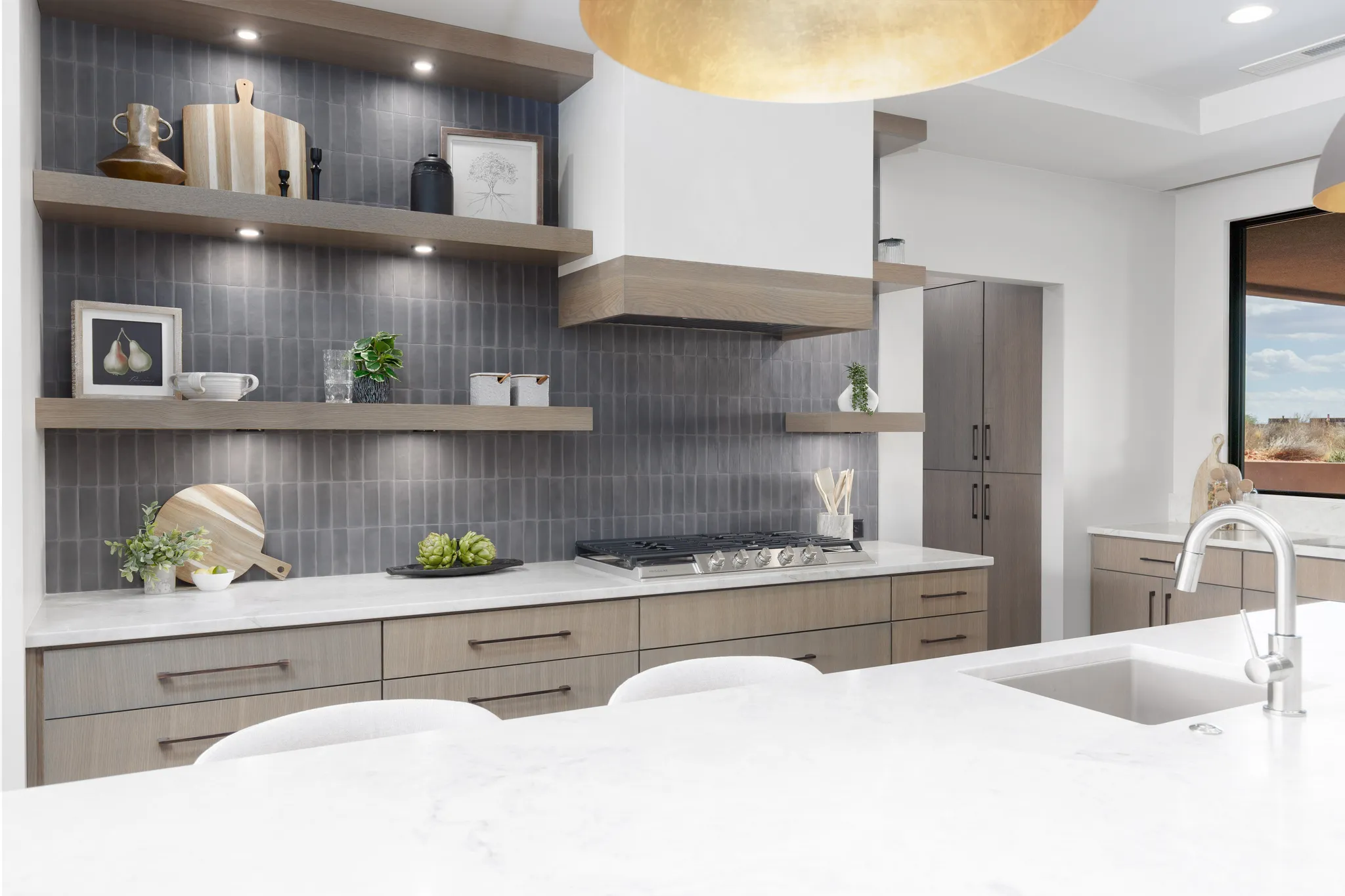 What a kitchen! Custom cabinets, double sinks, quartzite counters, floating shelves, and tiled backsplashes.