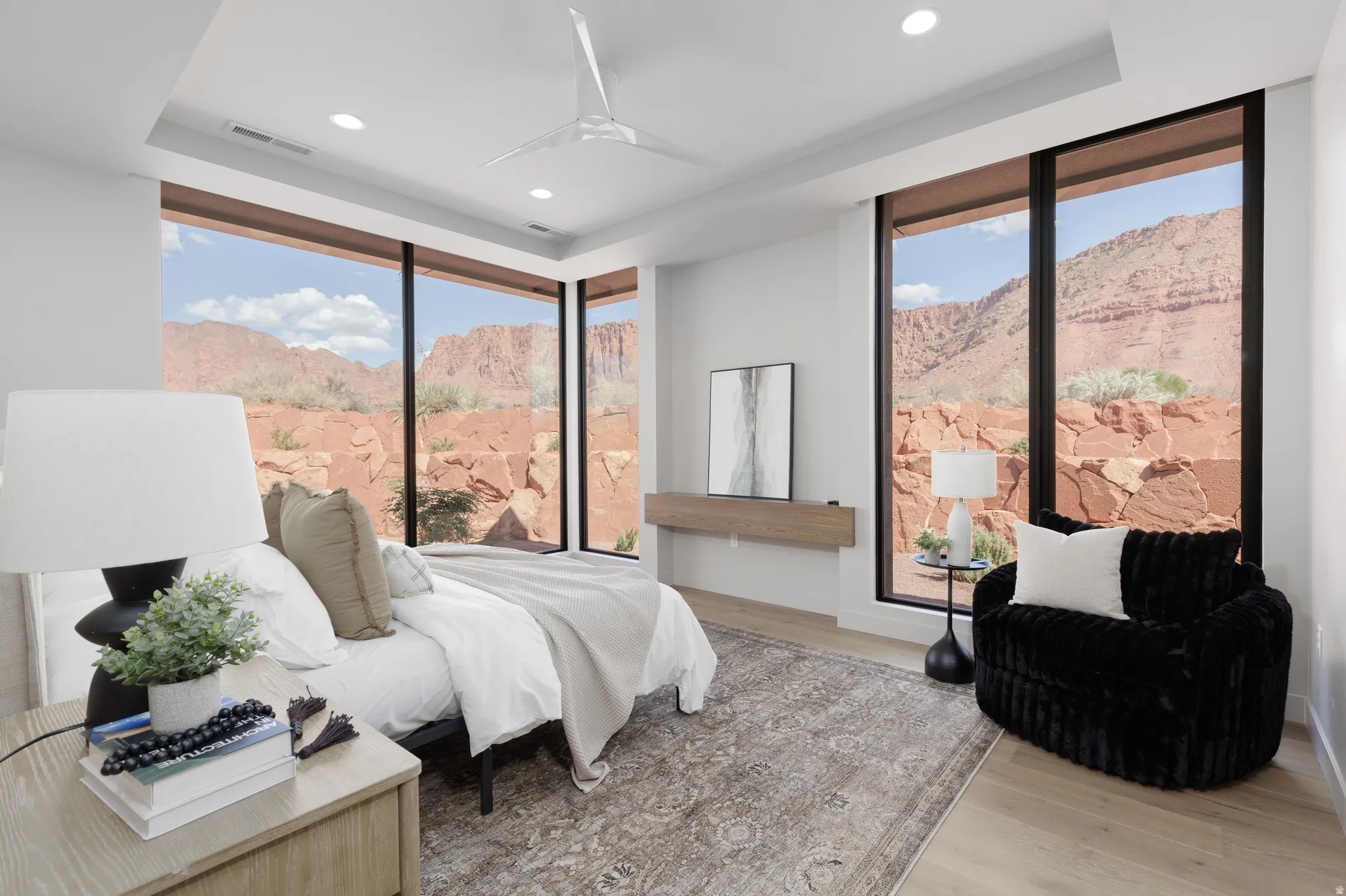 Secluded primary suite with floor to ceiling windows and custom builtins.