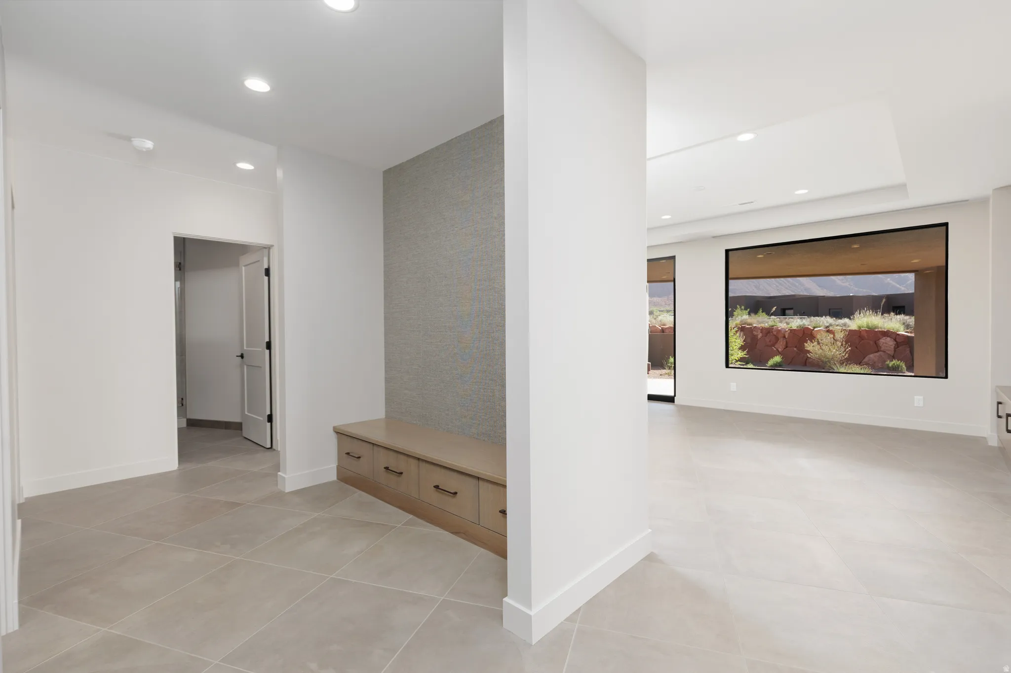 Locker area with custom bench for storage and wallpapered feature wall.