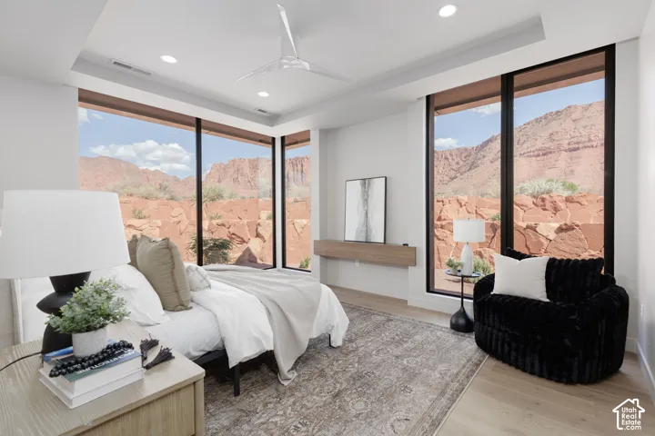 Secluded primary suite with floor to ceiling windows and custom builtins.