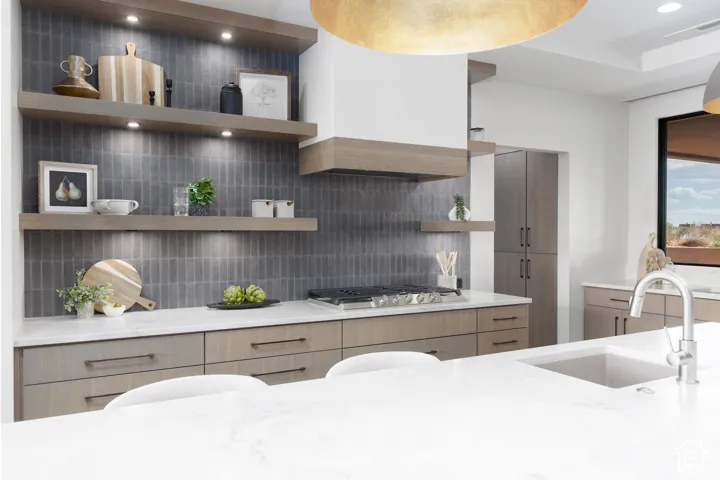 What a kitchen! Custom cabinets, double sinks, quartzite counters, floating shelves, and tiled backsplashes.
