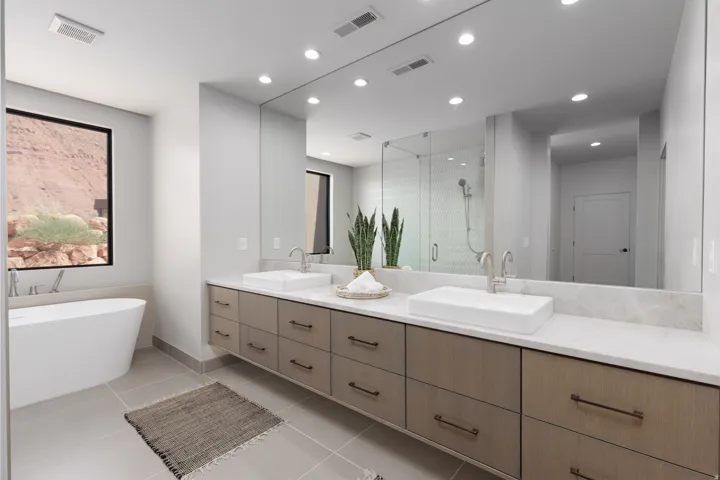 The perfect primary bathroom! Double sink vanity, freestanding soaking tub, large walk-in custom glass shower and don't forget the views!