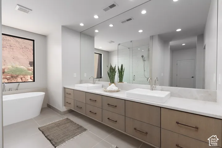 The perfect primary bathroom! Double sink vanity, freestanding soaking tub, large walk-in custom glass shower and don't forget the views!