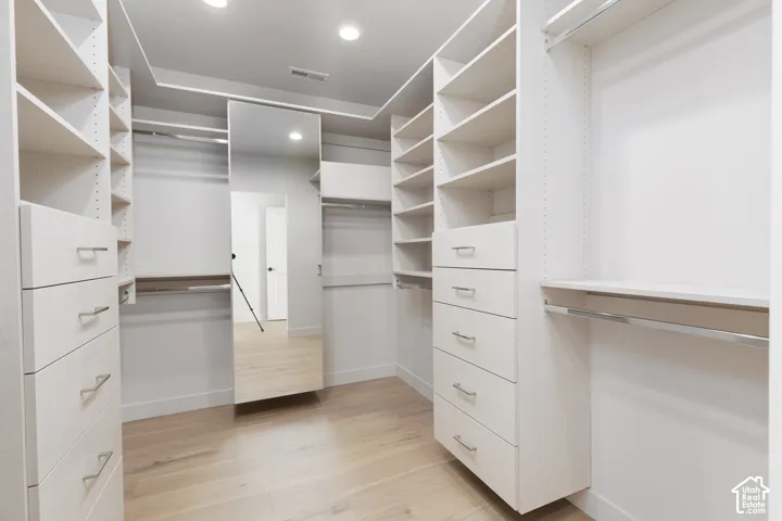 Primary closet with well planned custom drawers and shelving.