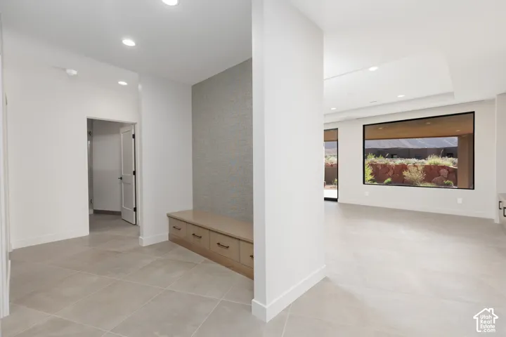 Locker area with custom bench for storage and wallpapered feature wall.