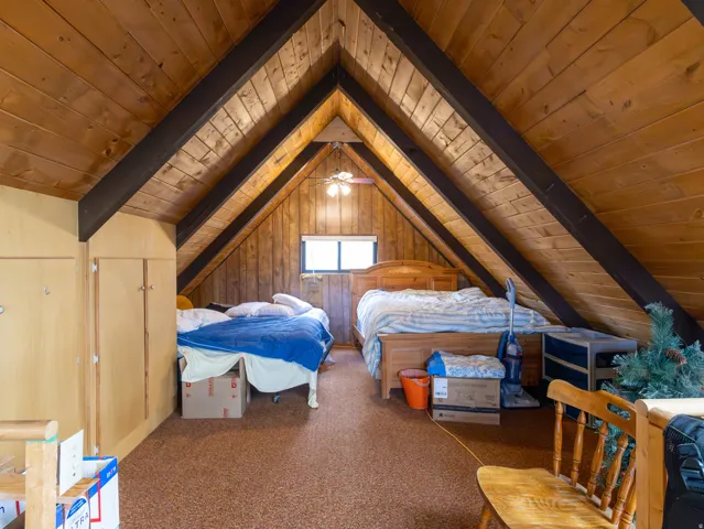 Vaulted wood-paneled ceilings with exposed dark wood beams