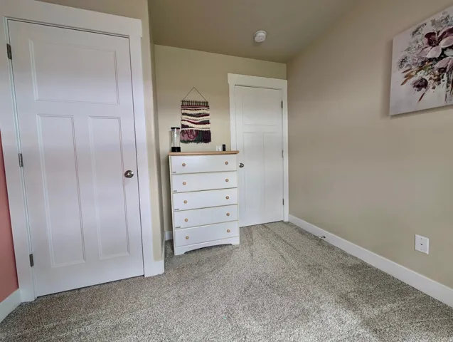 Neutral tone walls with white trim and carpeting