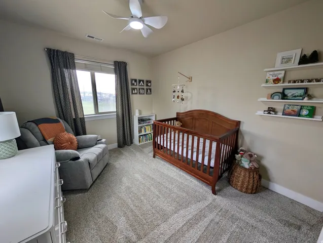 Neutral-toned walls and plush carpeting create a serene atmosphere