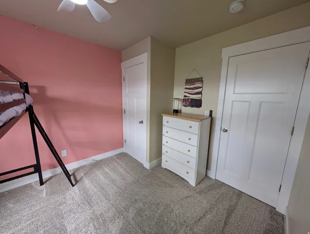 Room featuring neutral carpeting and a ceiling fan