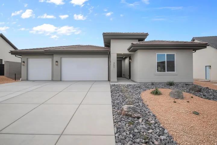 Contemporary stucco exterior with a multi-car driveway and an integrated garage