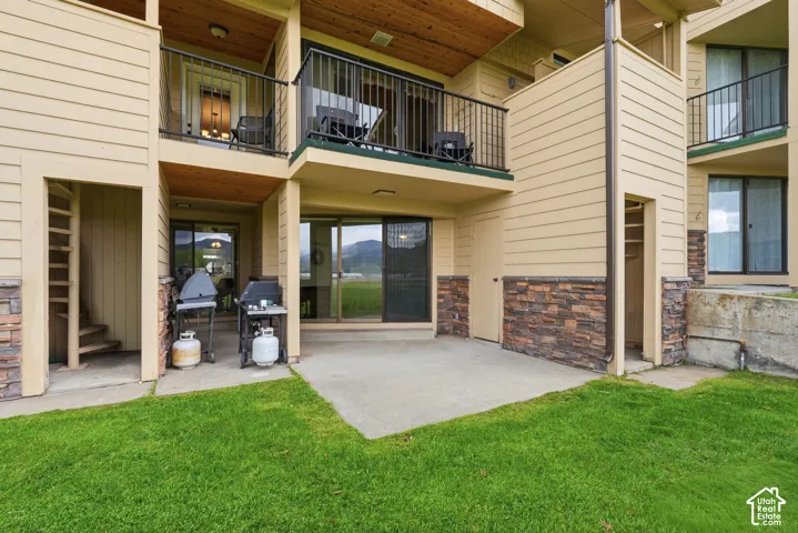 Concrete patio with stone veneer accents and horizontal siding