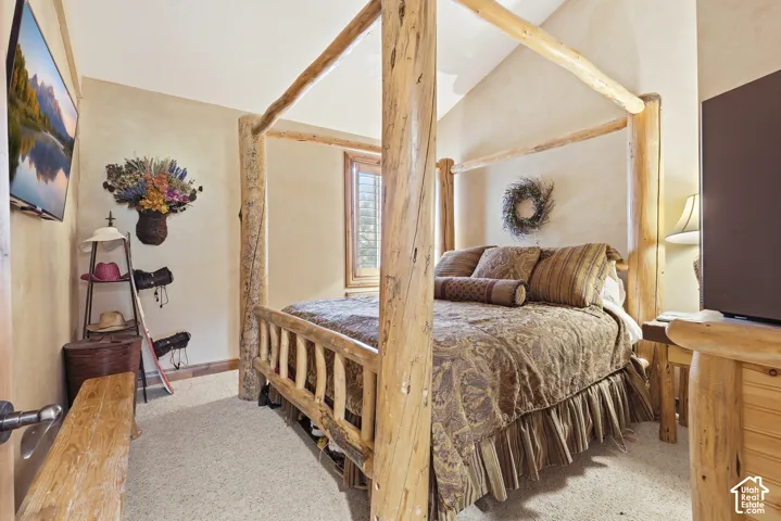 Rustic bedroom with textured wall finish and wood-finish door