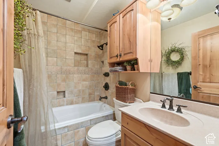 Bathroom featuring a built-in bathtub with tiled surround, integrated shower niche, and dark bronze fixtures