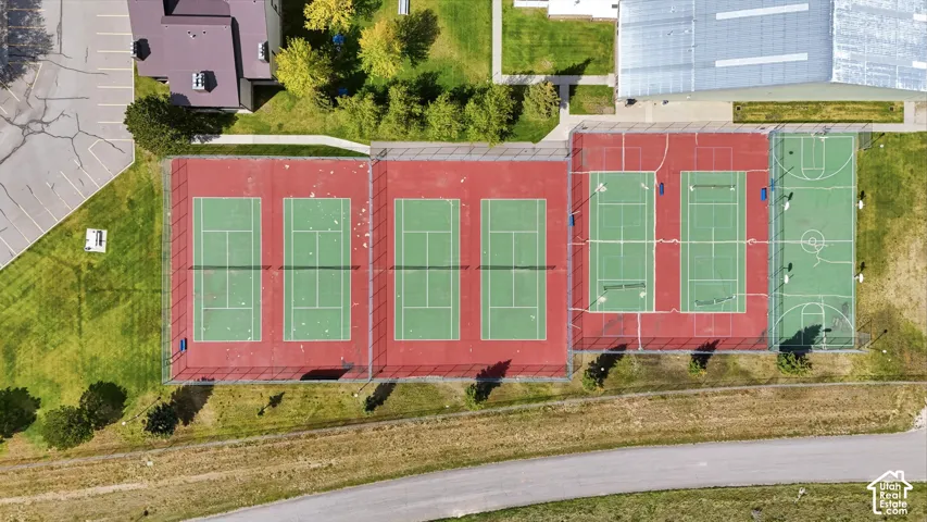 Sports complex featuring three tennis courts, two multi-sport courts, and a basketball court