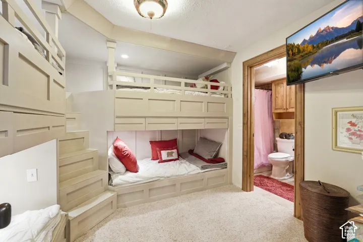 Built-in bunk beds with integrated storage drawers and a custom staircase