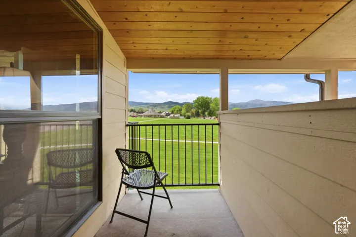 Covered balcony with wood-plank ceiling and concrete flooring