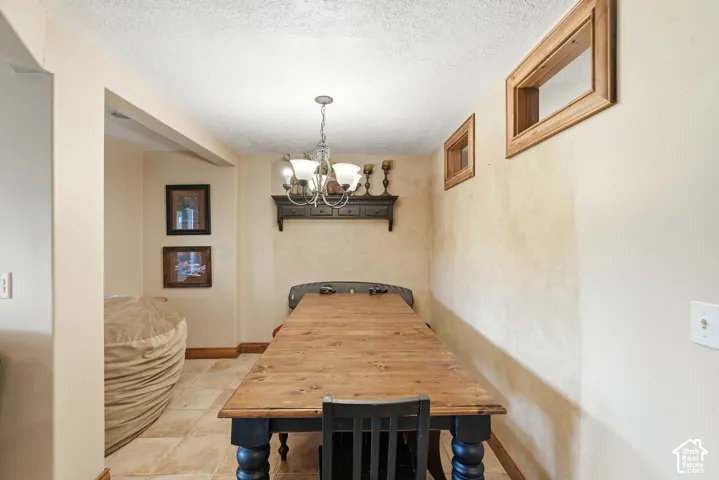 Dining area featuring tile flooring and a ceiling-mounted light fixture