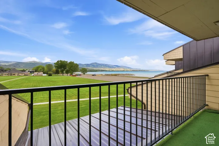 Balcony featuring black metal railings and artificial turf flooring