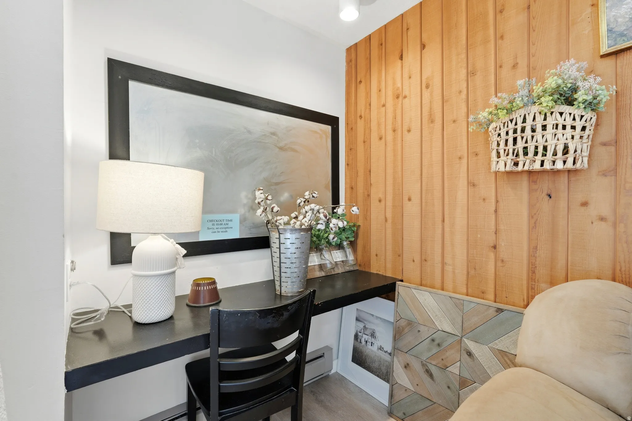 Built-in desk featuring a dark countertop and a prominent wood plank accent wall