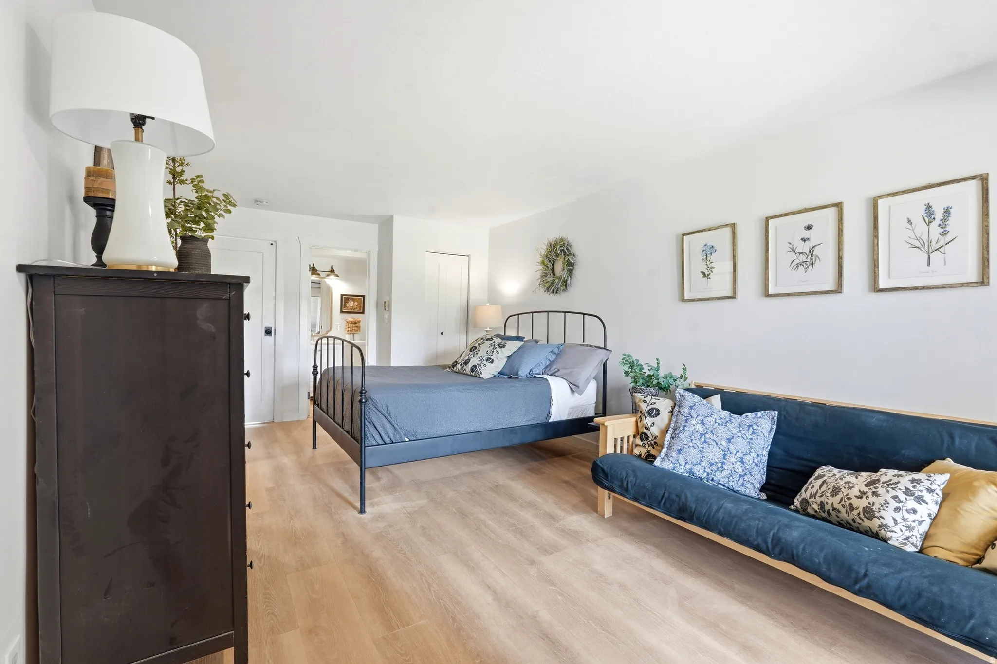 Spacious room featuring light wood-finish flooring, white walls, and a recessed doorway