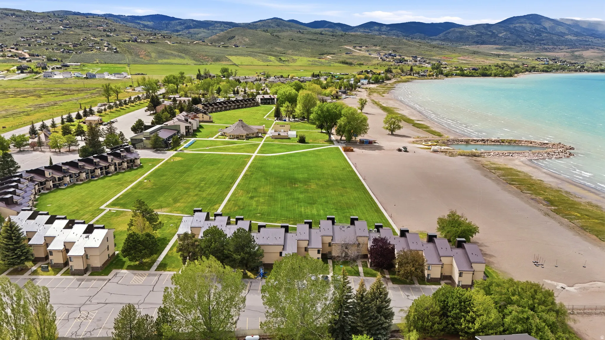 Expansive beachfront property featuring direct shoreline access and mountain vistas
