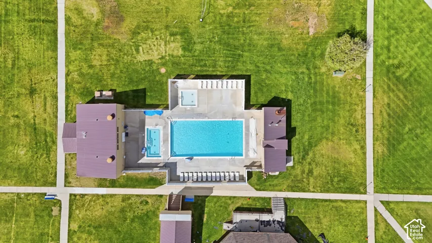 Community recreation area featuring a large swimming pool, a smaller wading pool, and an integrated spa