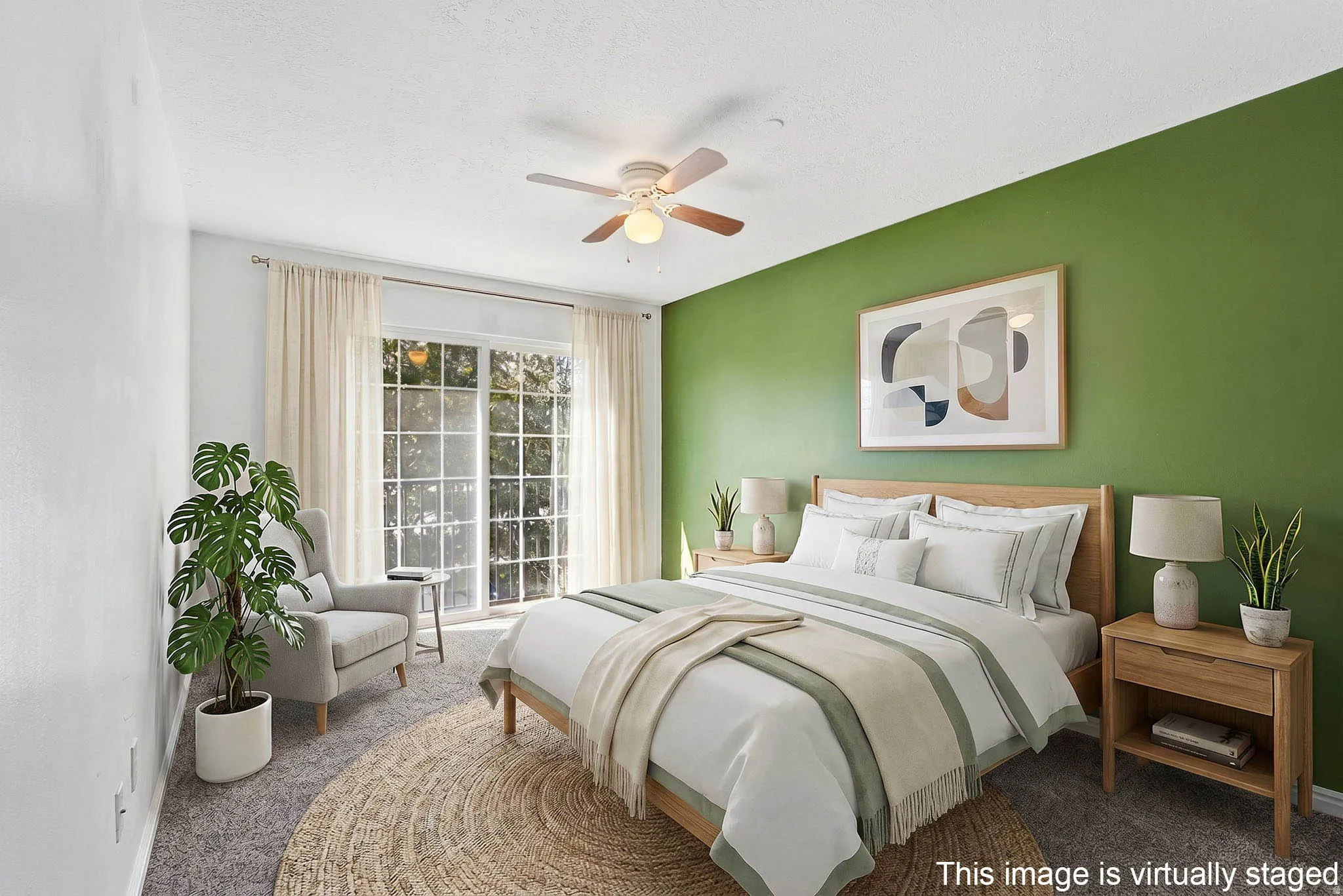 Room featuring a sliding glass door with muntins, a ceiling fan, and carpeted flooring