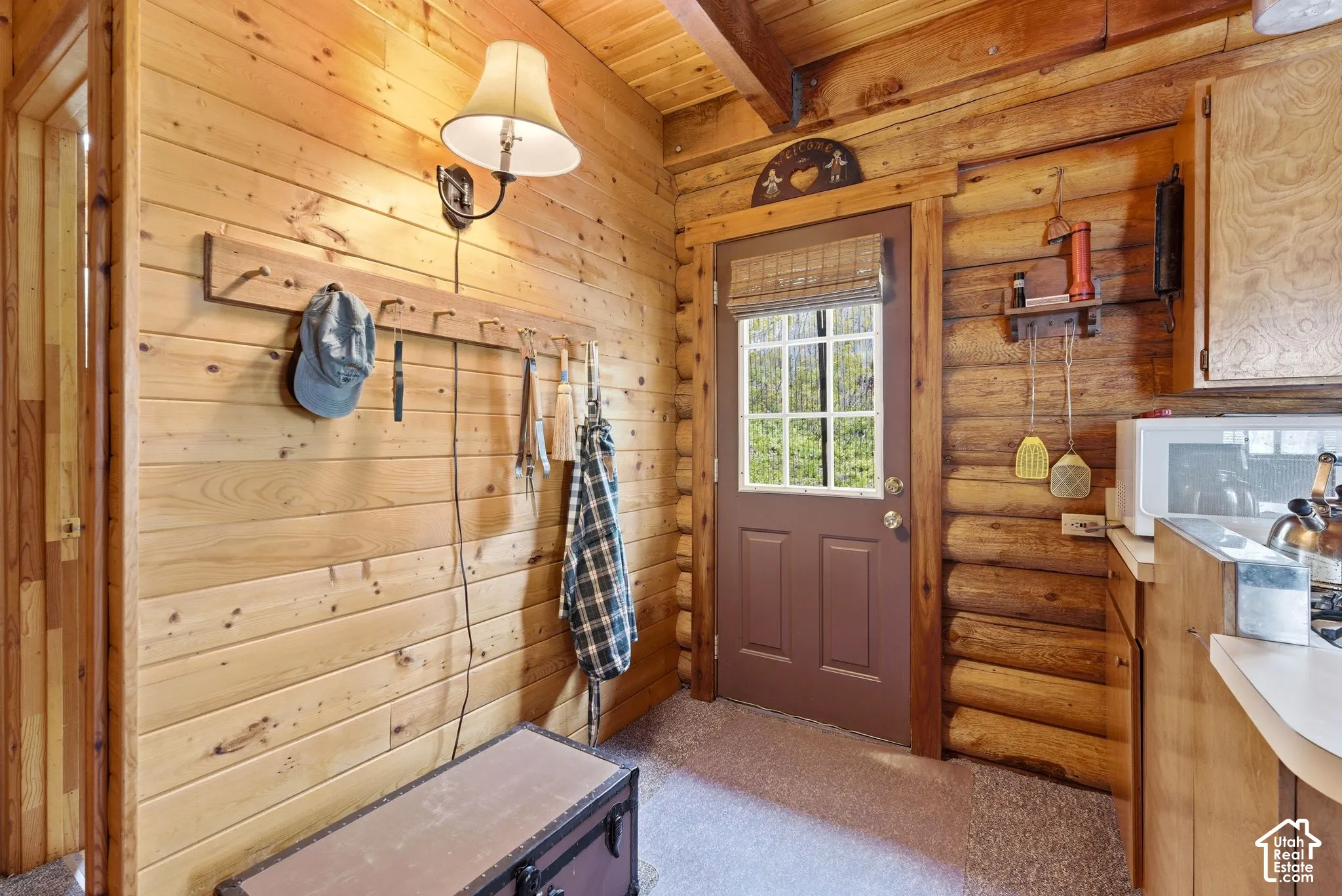 Rustic interior featuring natural wood plank walls and a log accent wall