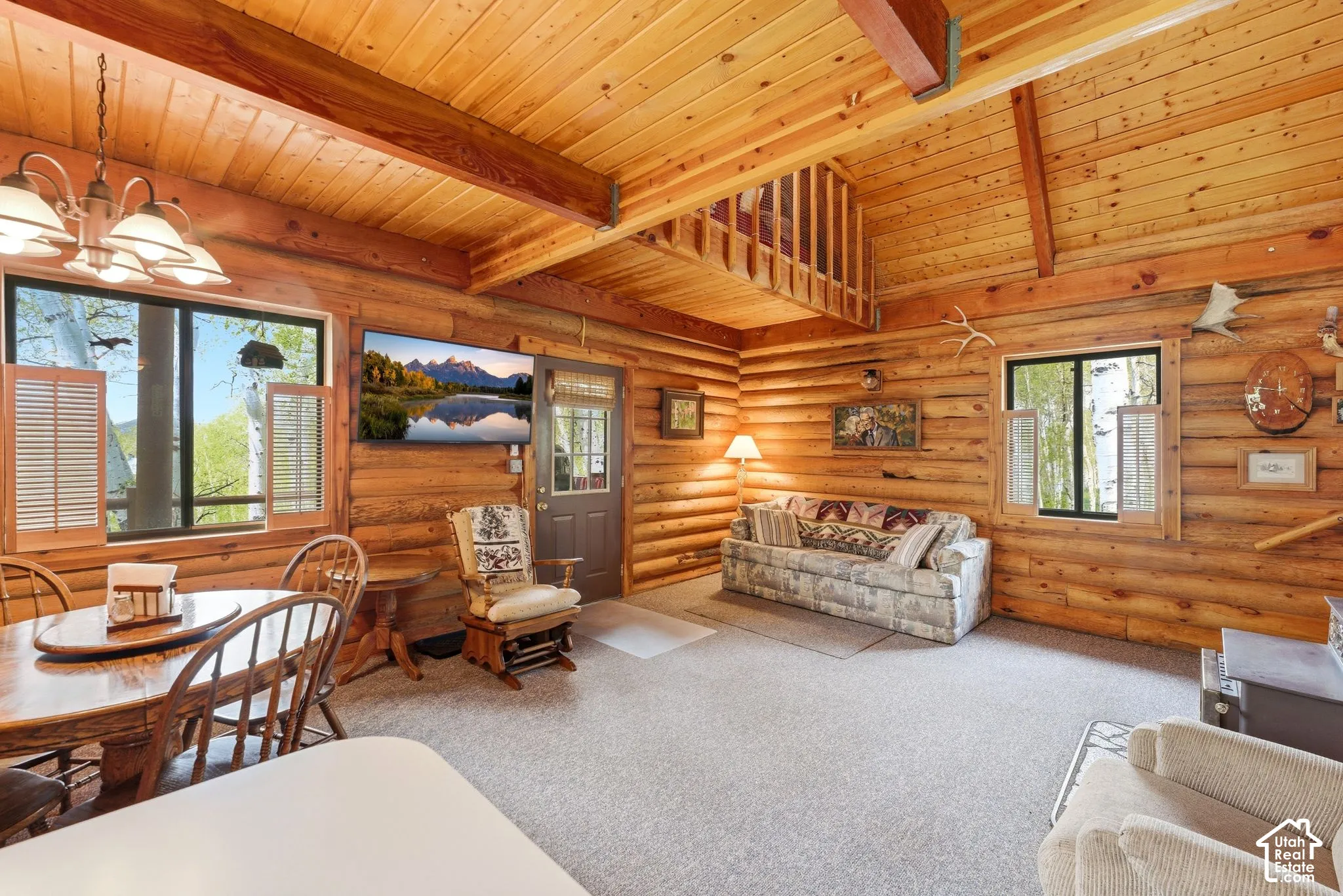 Expansive great room featuring log walls and wood-finish flooring