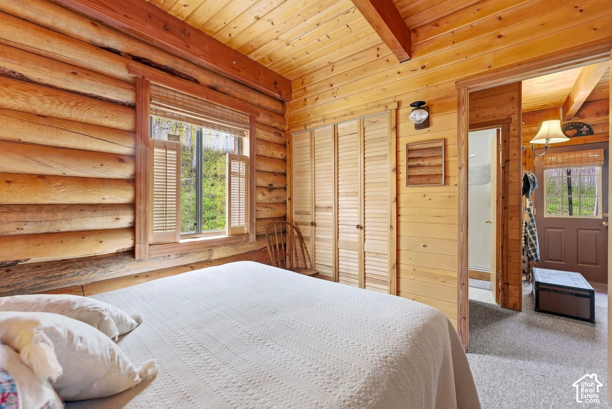 Log cabin interior with exposed wood beam ceilings and wood-paneled walls