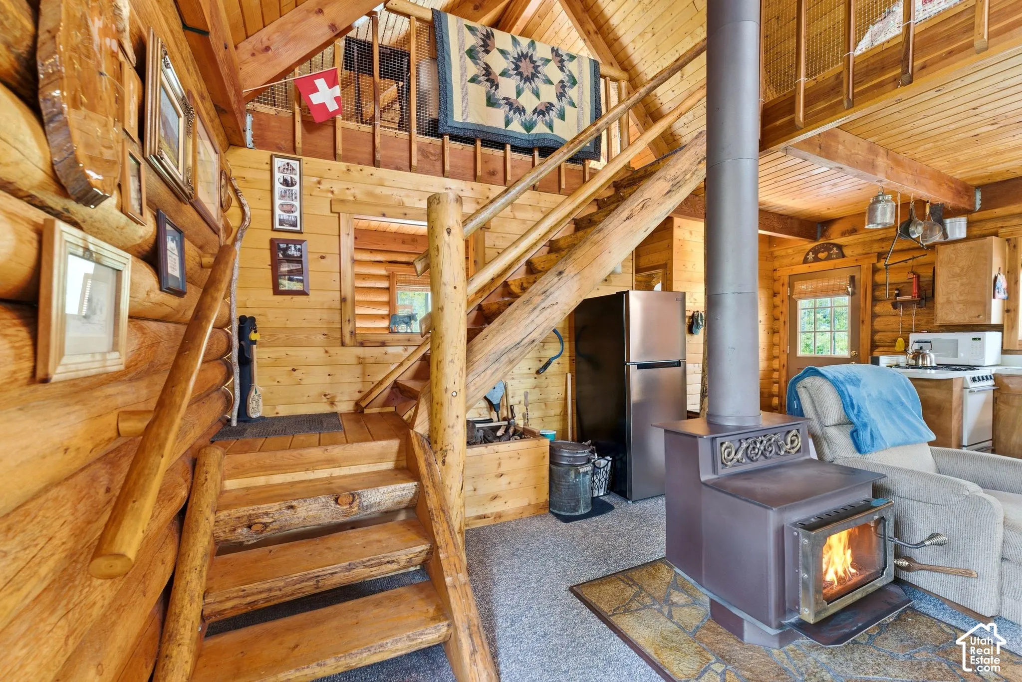Rustic interior featuring natural log walls and exposed wood beams