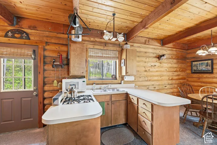 Log cabin interior featuring exposed wood beams and log walls
