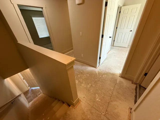 Unit B - Upper landing with neutral wall paint and multiple doorways