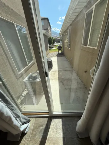Unit B - Sliding glass door leading to a concrete patio