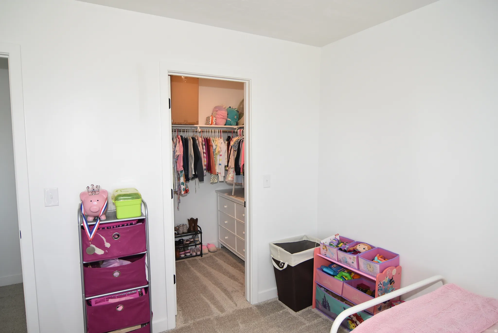 Bedroom #3 with Walk-in closet with built-in shelving, hanging rods, and a white dresser-style storage unit