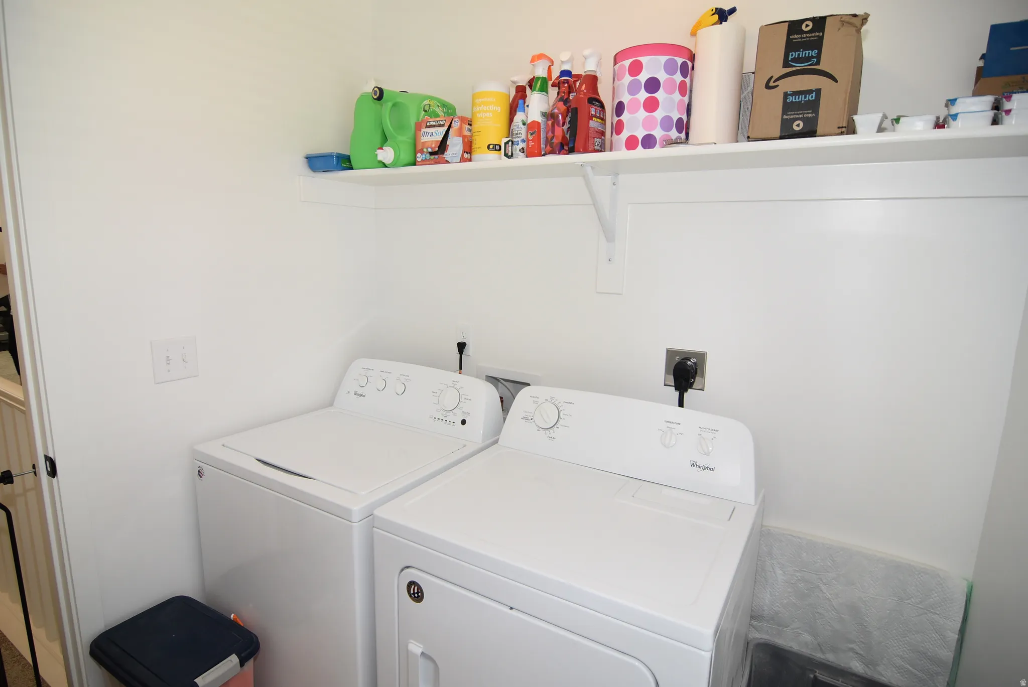 Dedicated laundry area featuring a built-in white shelf