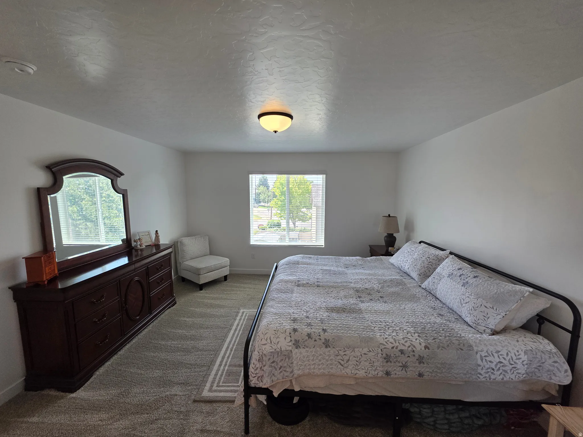 Spacious room featuring neutral carpeting and white walls