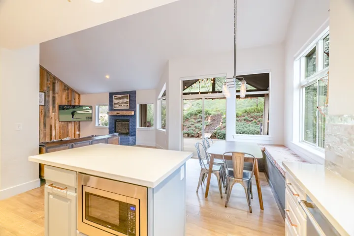 Open-concept living space featuring wood-finish flooring and high ceilings