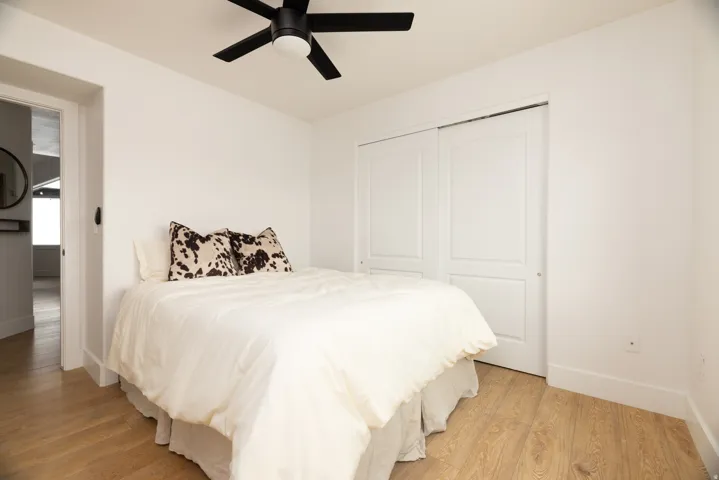Light wood-finish flooring complements the bright white wall paint