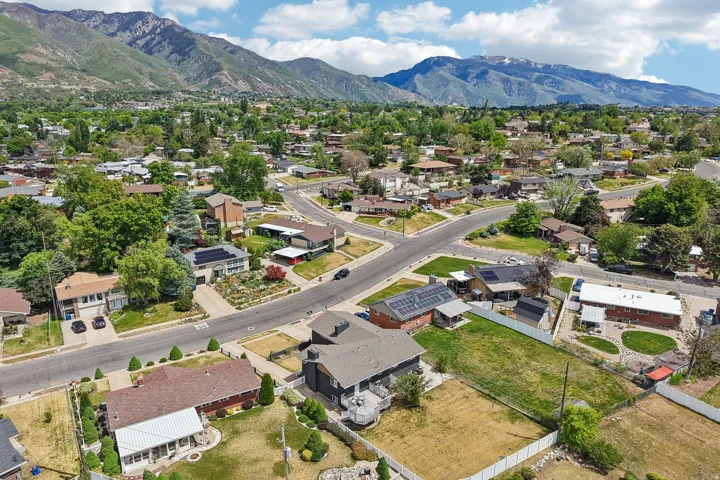 Aerial perspective showcasing the residential neighborhood with a backdrop of prominent mountains