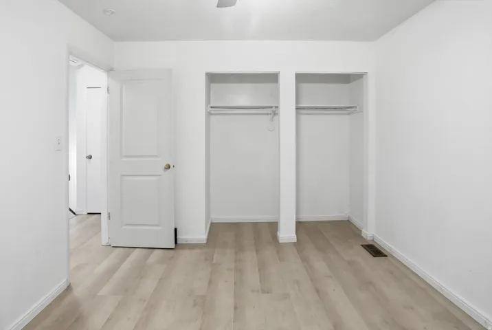 Room featuring light wood-finish flooring, white walls, and white baseboards