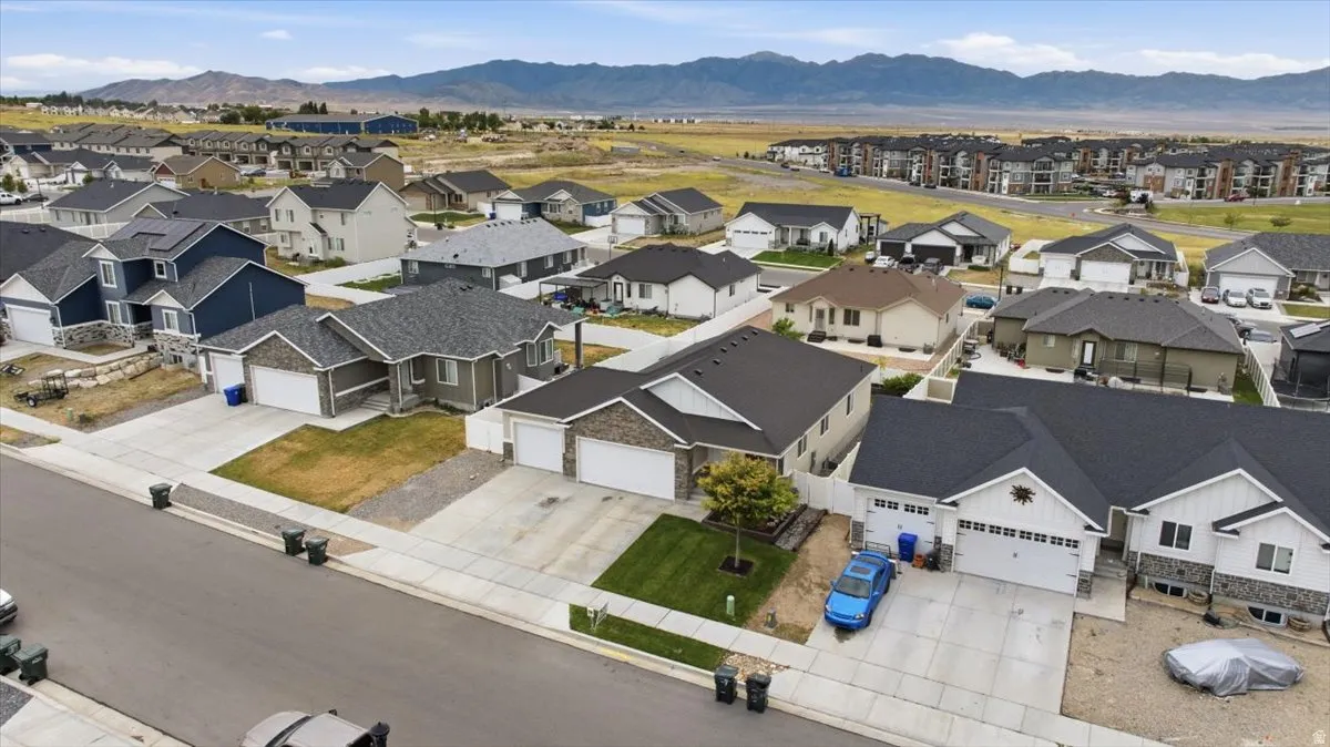 Residential neighborhood featuring a variety of single-family homes with distinct architectural styles, dark shingle roofs, and concrete driveways