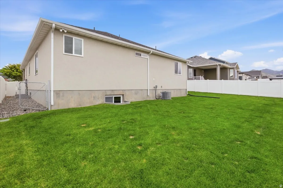 Expansive green lawn with a white vinyl fence