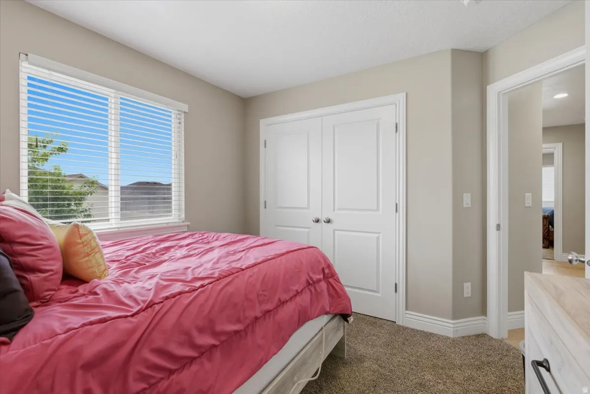 Neutral tone walls complement the textured brown carpeting