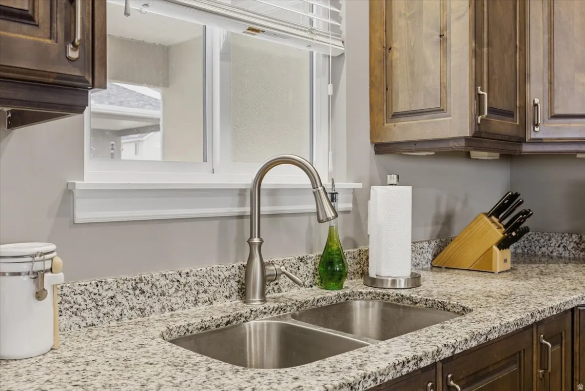 Dual basin stainless steel sink with a high-arc brushed nickel faucet